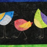 3 colorful birds on black