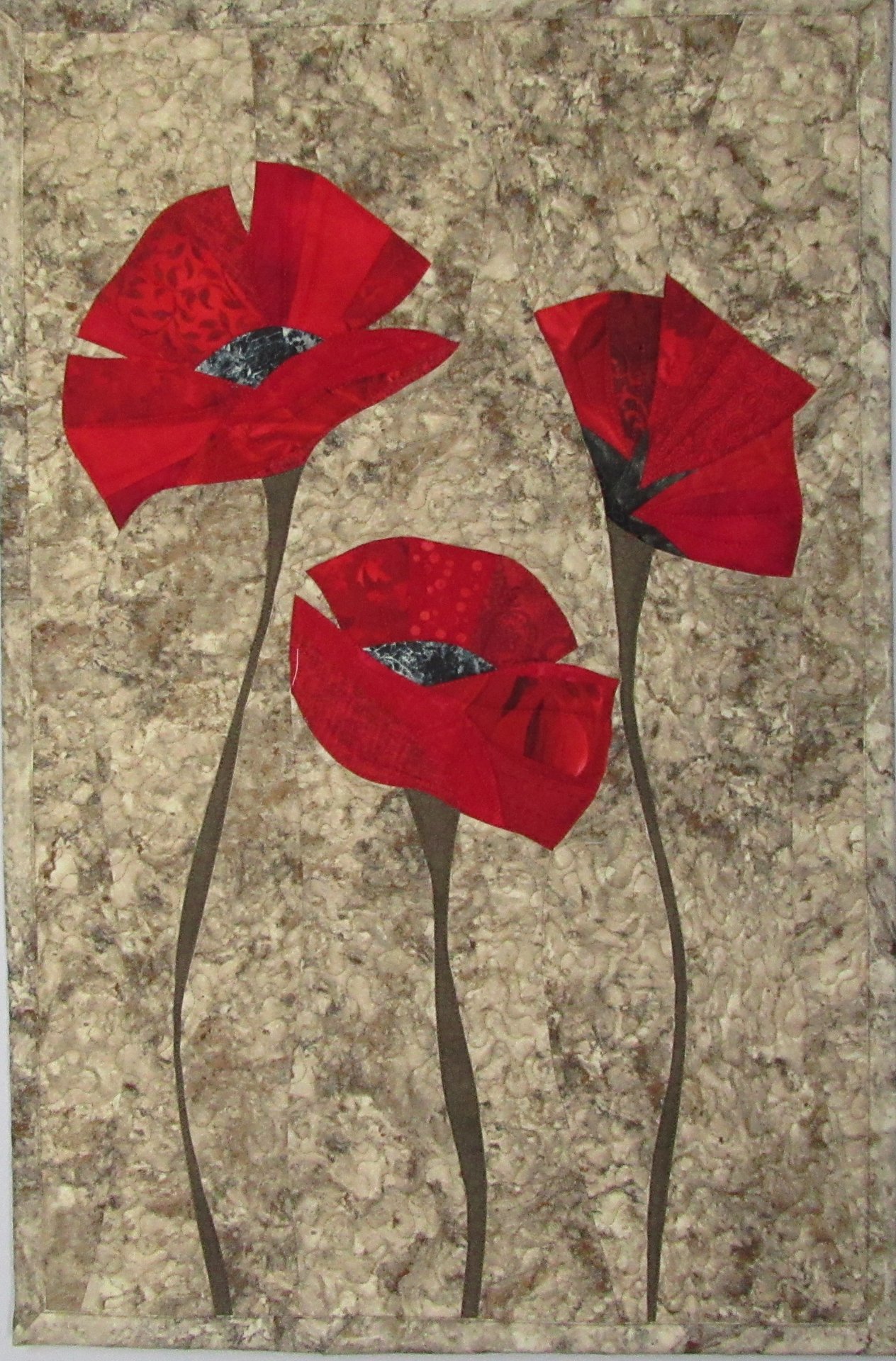 Three red poppies on grey 2017