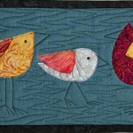 3 colorful birds on blue